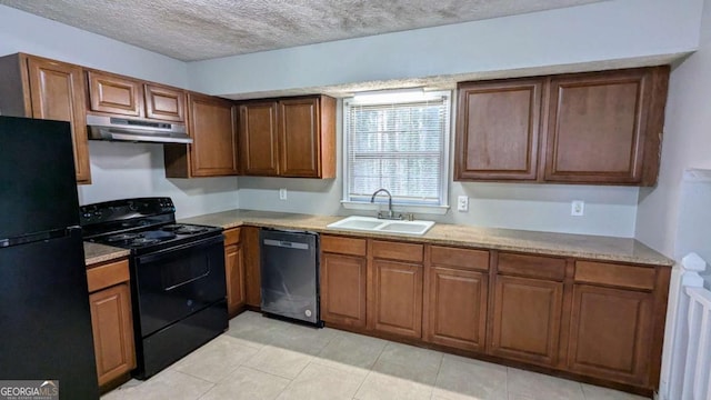 kitchen featuring black appliances, light tile patterned floors, sink, and a textured ceiling