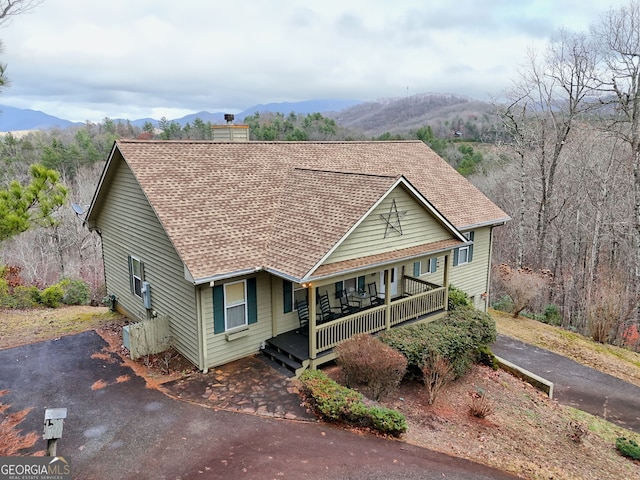 view of front of home featuring covered porch and a mountain view