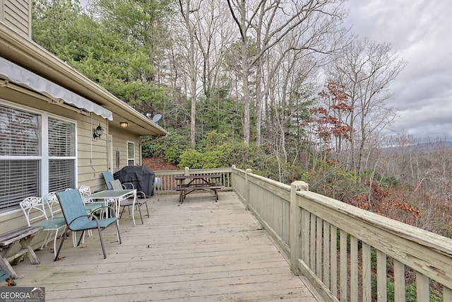 wooden terrace with area for grilling