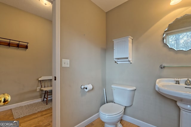 bathroom featuring toilet and hardwood / wood-style flooring