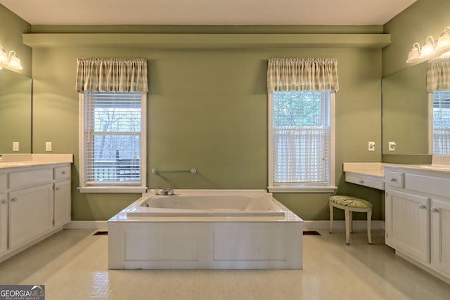 bathroom featuring a tub to relax in, a wealth of natural light, and vanity