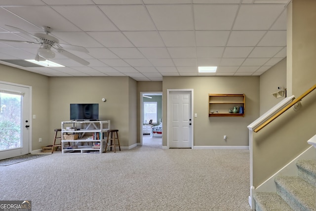 interior space featuring carpet, ceiling fan, and a drop ceiling