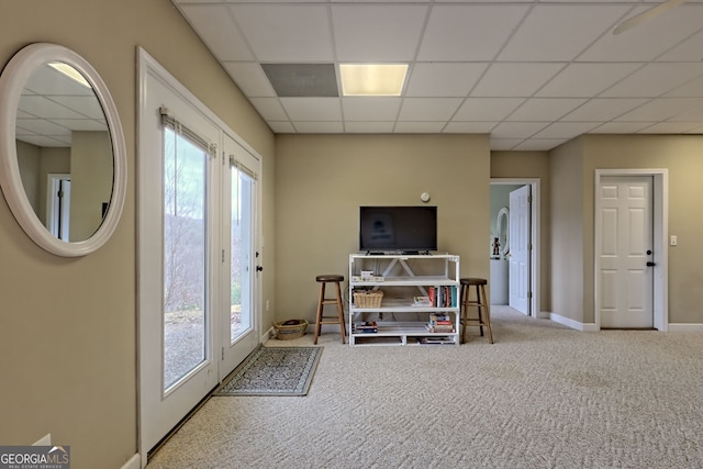 interior space featuring light carpet and a drop ceiling