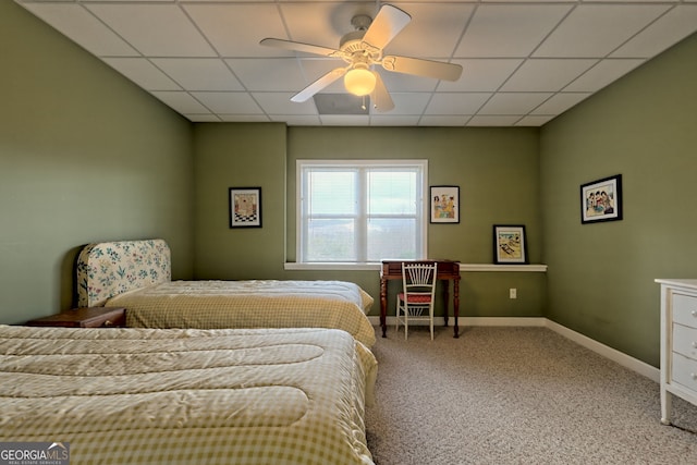 bedroom featuring a paneled ceiling, ceiling fan, and carpet floors