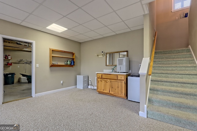 interior space with carpet flooring and a drop ceiling