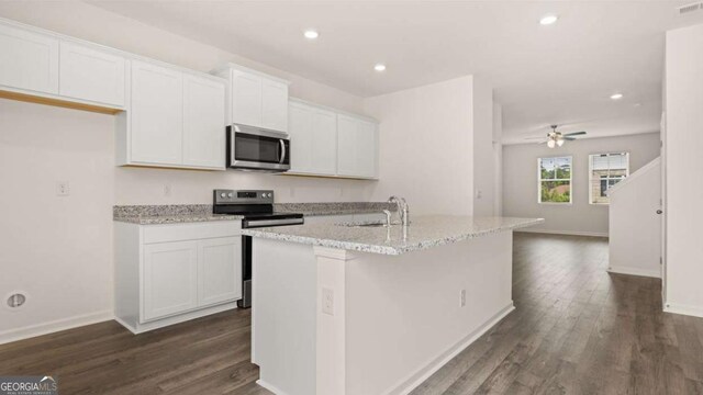 kitchen with white cabinetry, a center island with sink, and appliances with stainless steel finishes