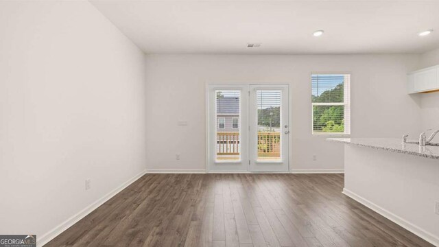 unfurnished dining area featuring dark hardwood / wood-style flooring and sink