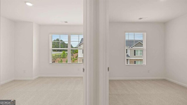 empty room featuring light colored carpet