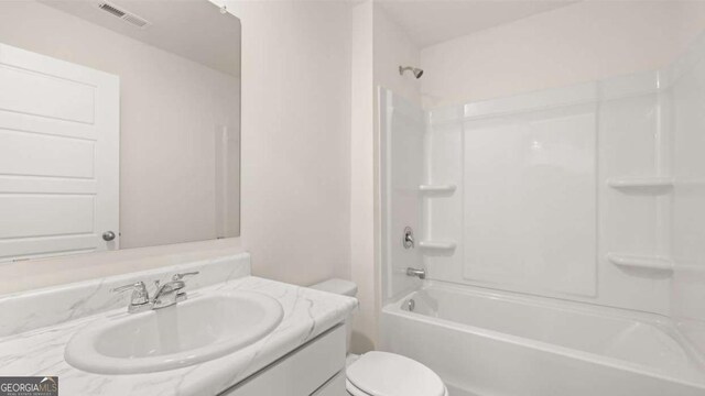 full bathroom with vanity, bathtub / shower combination, and toilet