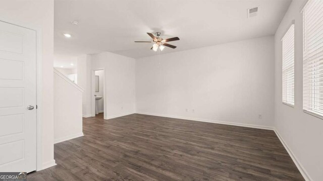 spare room with ceiling fan and dark wood-type flooring