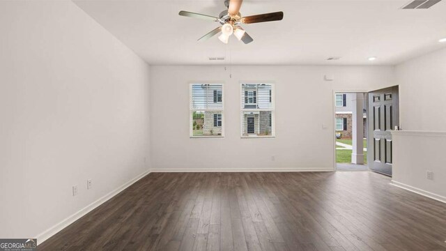 unfurnished room with dark hardwood / wood-style floors and ceiling fan