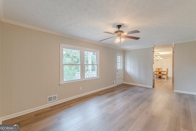 spare room featuring crown molding, ceiling fan with notable chandelier, a textured ceiling, and light hardwood / wood-style flooring