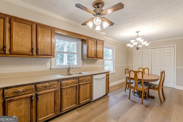 kitchen featuring sink, decorative light fixtures, a textured ceiling, ornamental molding, and dishwasher