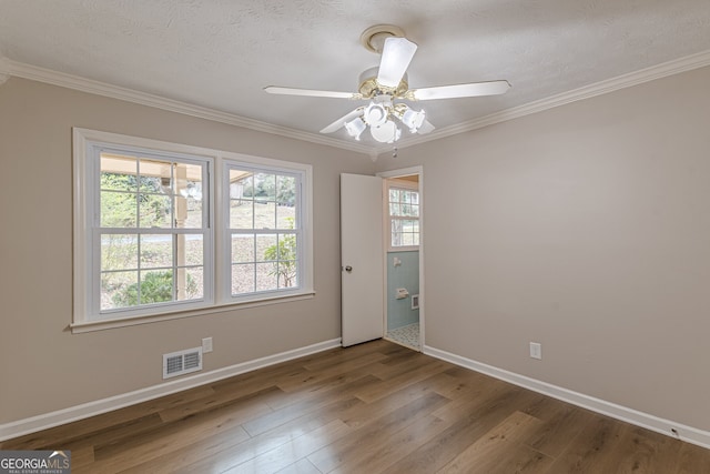 unfurnished room with crown molding, ceiling fan, hardwood / wood-style floors, and a textured ceiling