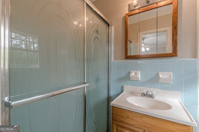 bathroom featuring vanity, tile walls, an enclosed shower, and ceiling fan