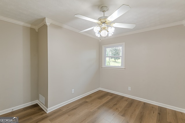 unfurnished room with hardwood / wood-style floors, ornamental molding, and ceiling fan