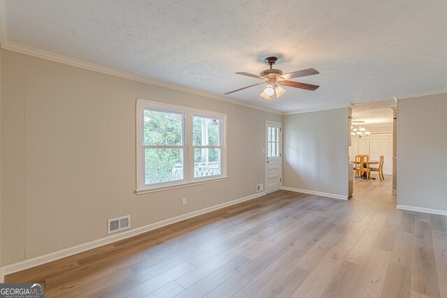 4485 Canary Ct, Lithia Springs, GA 30122 - foyer featuring a textured ceiling, wood finished floors, baseboards, and crown molding