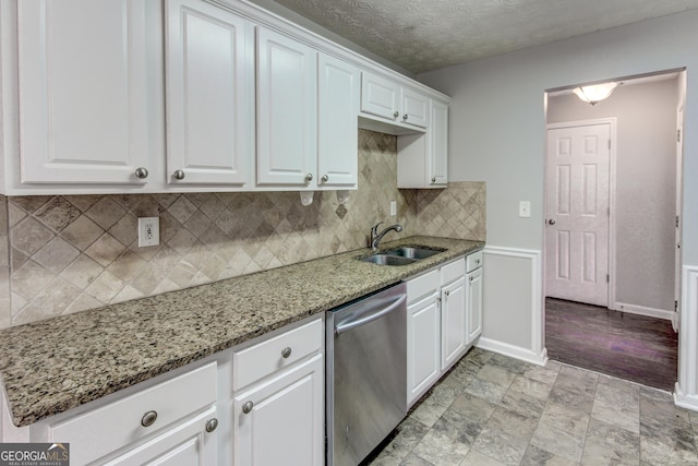 1624 Graystone Dr, Hampton, GA 30228 - kitchen featuring stainless steel dishwasher, white cabinets, light stone counters, backsplash, and a textured ceiling