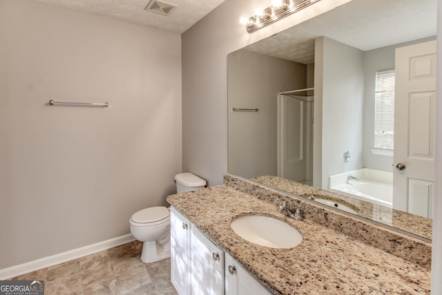 full bathroom featuring vanity, a textured ceiling, toilet, and separate shower and tub