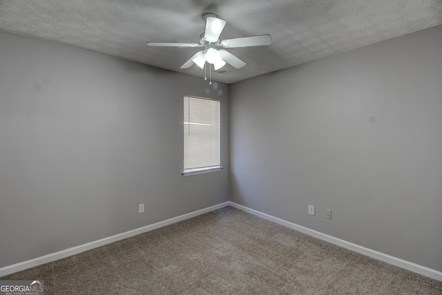 carpeted spare room with ceiling fan and a textured ceiling