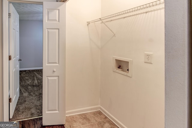 washroom with washer hookup and a textured ceiling