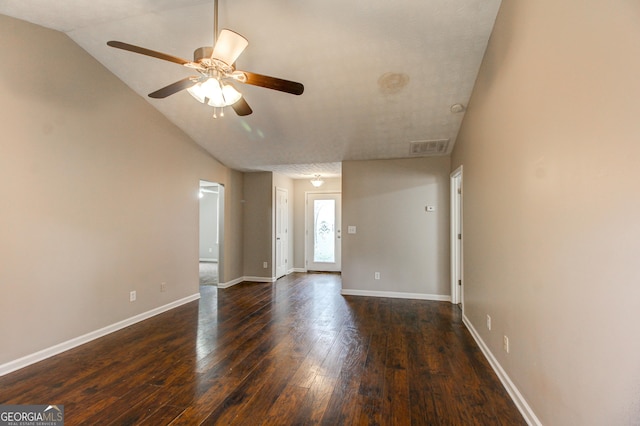 spare room featuring ceiling fan, dark hardwood / wood-style flooring, and lofted ceiling