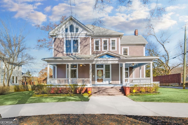 view of front of property with covered porch and a front yard