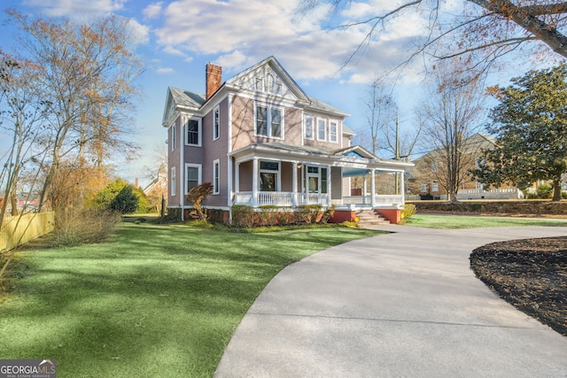 view of front of property with a porch and a front yard