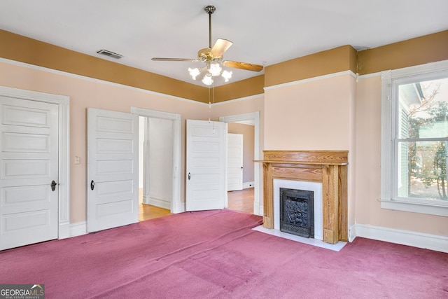 unfurnished living room with ceiling fan and carpet floors