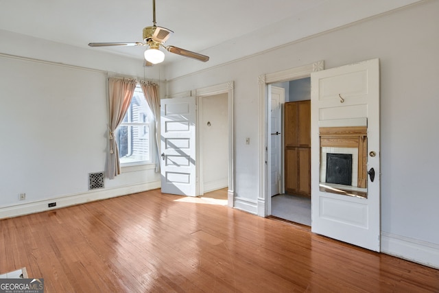 empty room with ceiling fan and wood-type flooring