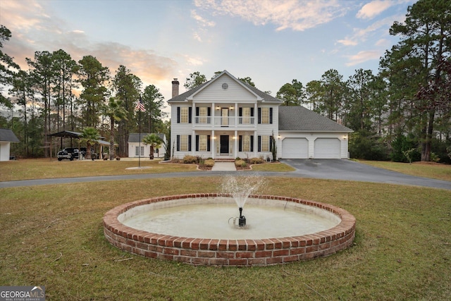 neoclassical / greek revival house featuring a lawn and a balcony