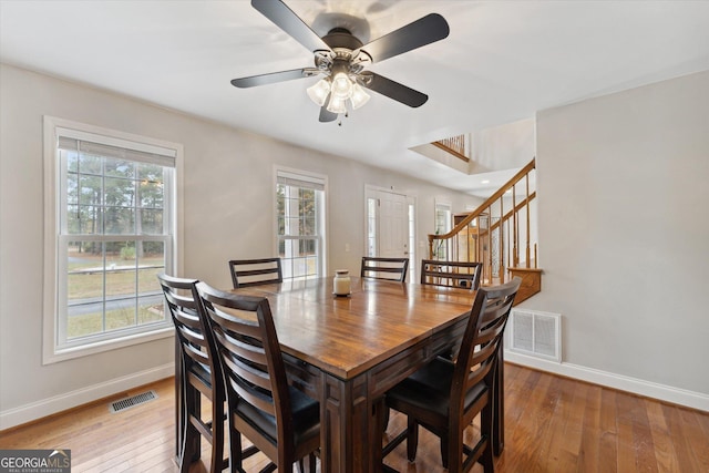 dining room with ceiling fan and hardwood / wood-style floors