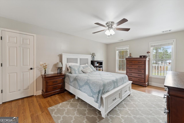 bedroom with ceiling fan and light hardwood / wood-style floors