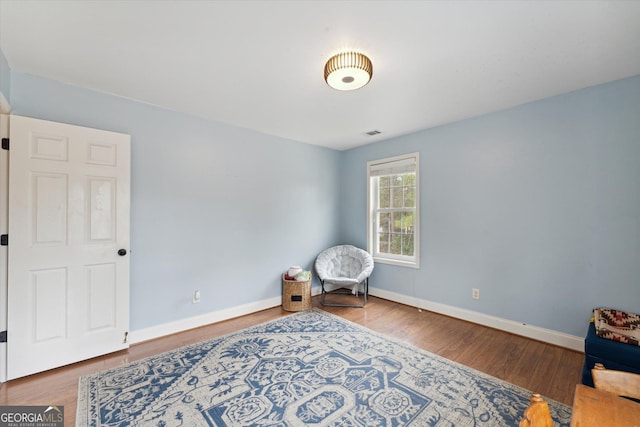 sitting room with hardwood / wood-style flooring