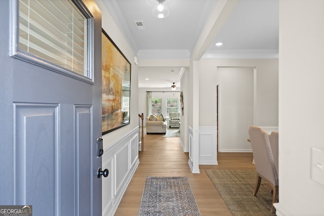 foyer with ceiling fan, light hardwood / wood-style flooring, and ornamental molding