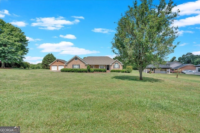 ranch-style home featuring a garage and a front yard