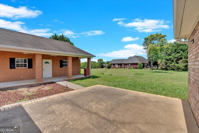 view of yard featuring a patio area and covered porch