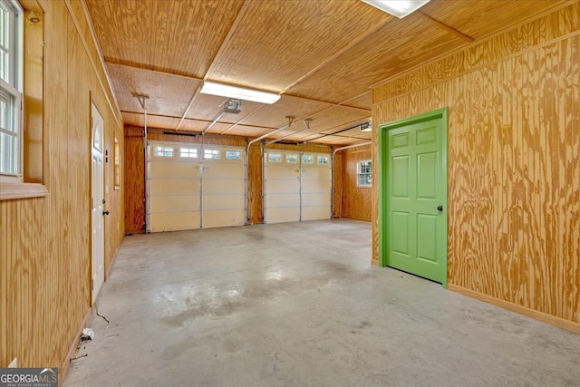 garage featuring wood walls and a garage door opener