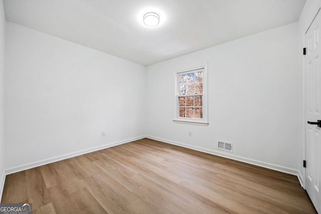 spare room with light hardwood / wood-style flooring