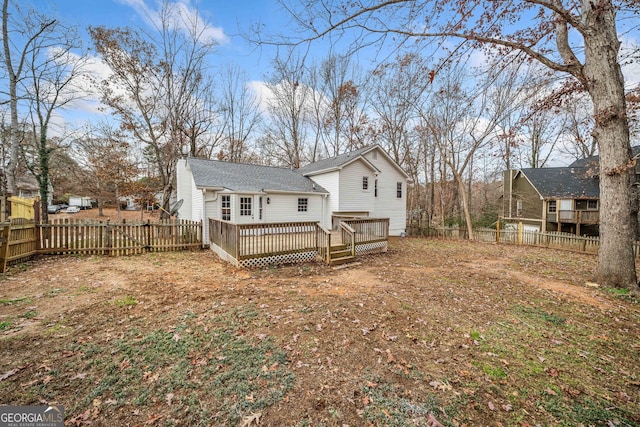 back of house featuring a wooden deck