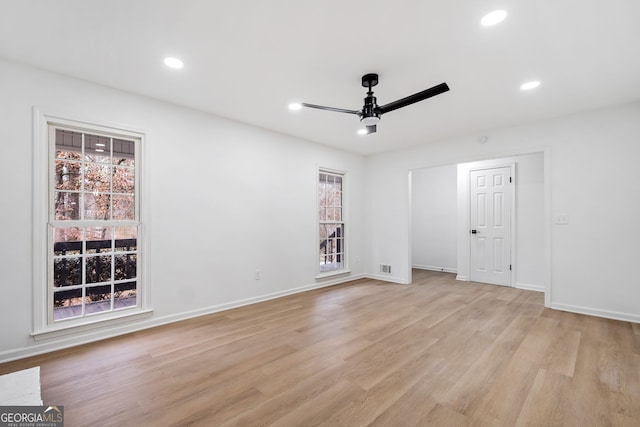 unfurnished room with light wood-type flooring and ceiling fan