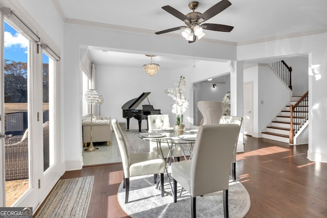 dining space featuring ceiling fan with notable chandelier, dark hardwood / wood-style flooring, and ornamental molding