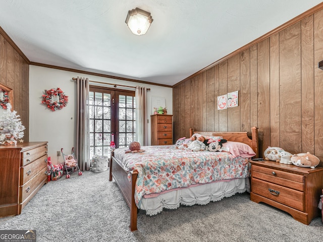 bedroom featuring light colored carpet, ornamental molding, and wooden walls