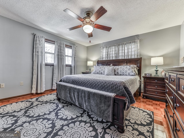 bedroom featuring ceiling fan, a textured ceiling, and light parquet floors