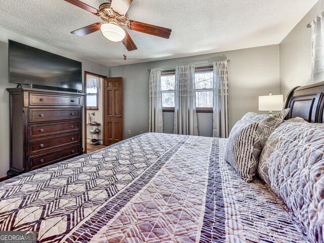 bedroom featuring a textured ceiling and ceiling fan