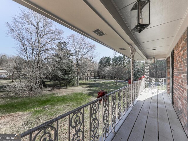 wooden terrace featuring covered porch