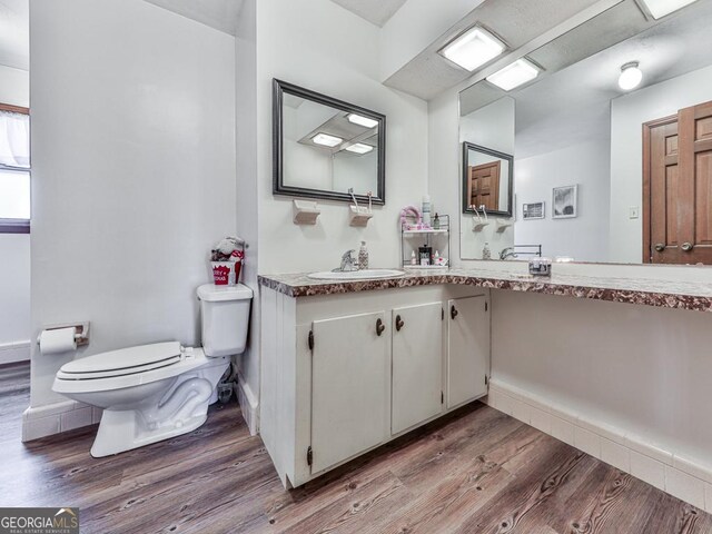 bathroom featuring hardwood / wood-style floors, vanity, and toilet