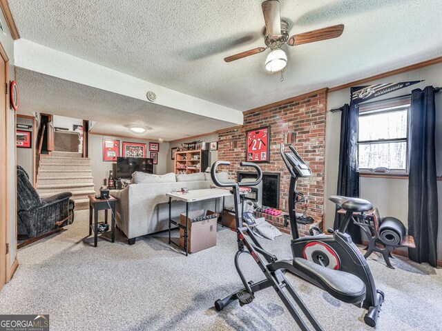 workout area with light carpet, ceiling fan, and a textured ceiling