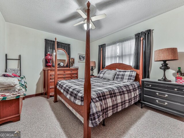 bedroom featuring carpet flooring, ceiling fan, and a textured ceiling