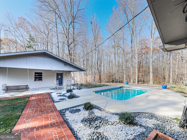 view of swimming pool featuring a patio area